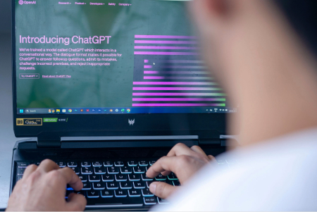 Man on computer webpage for ChatGPT introduction.